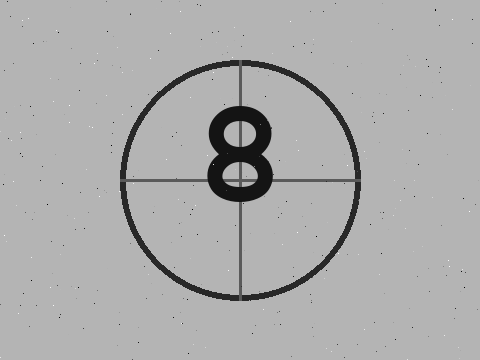 Animated engineering film: a film-leader countdown, then a slow pan over a stylized chip die photo. A frame counter in the corner stutters and skips.